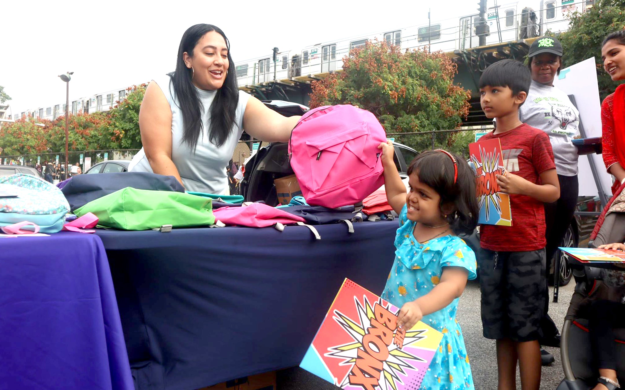 PICTURED: Council Member Amanda Farías distributing folders in Soundview