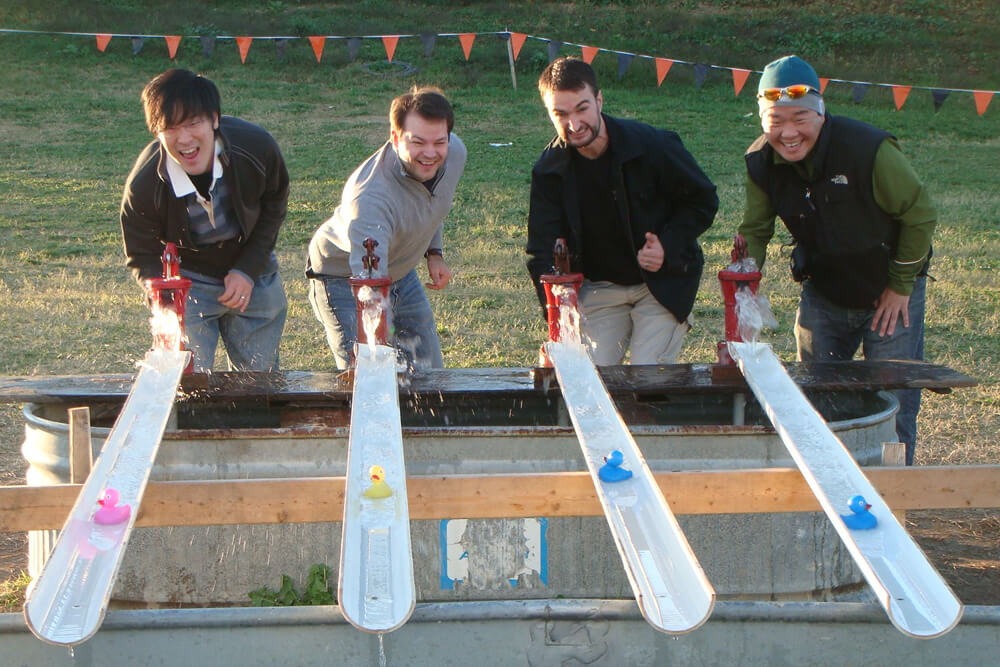 Four Men Racing Rubber Ducks