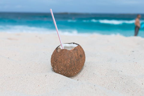 Coconut water on sandy beach and include electrolytes