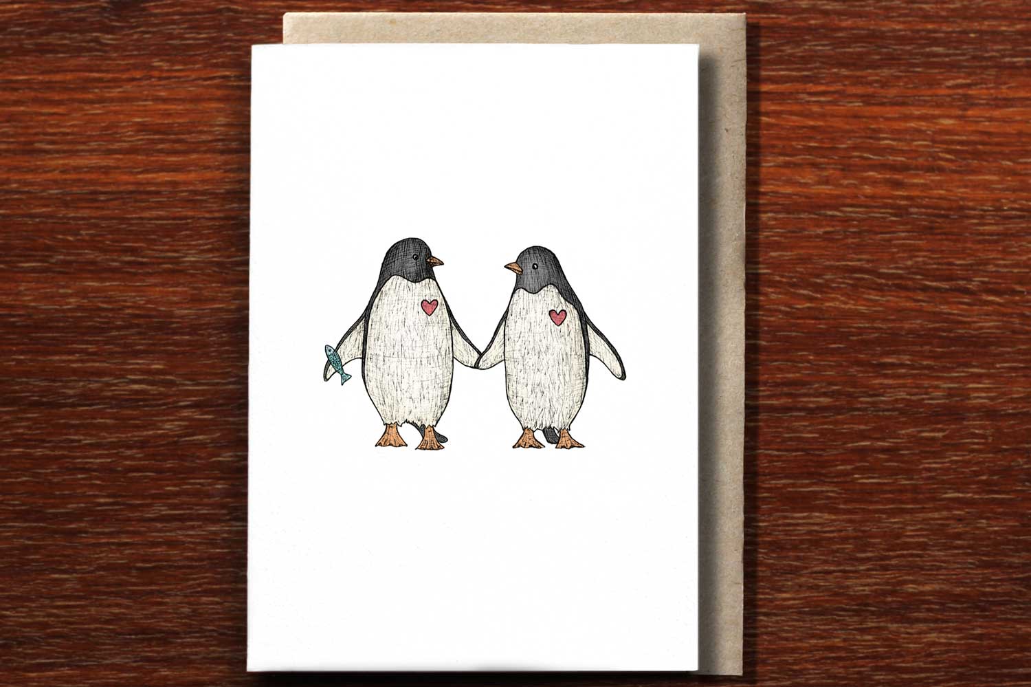 Hand illustrated wedding card with two penguins holding hands.