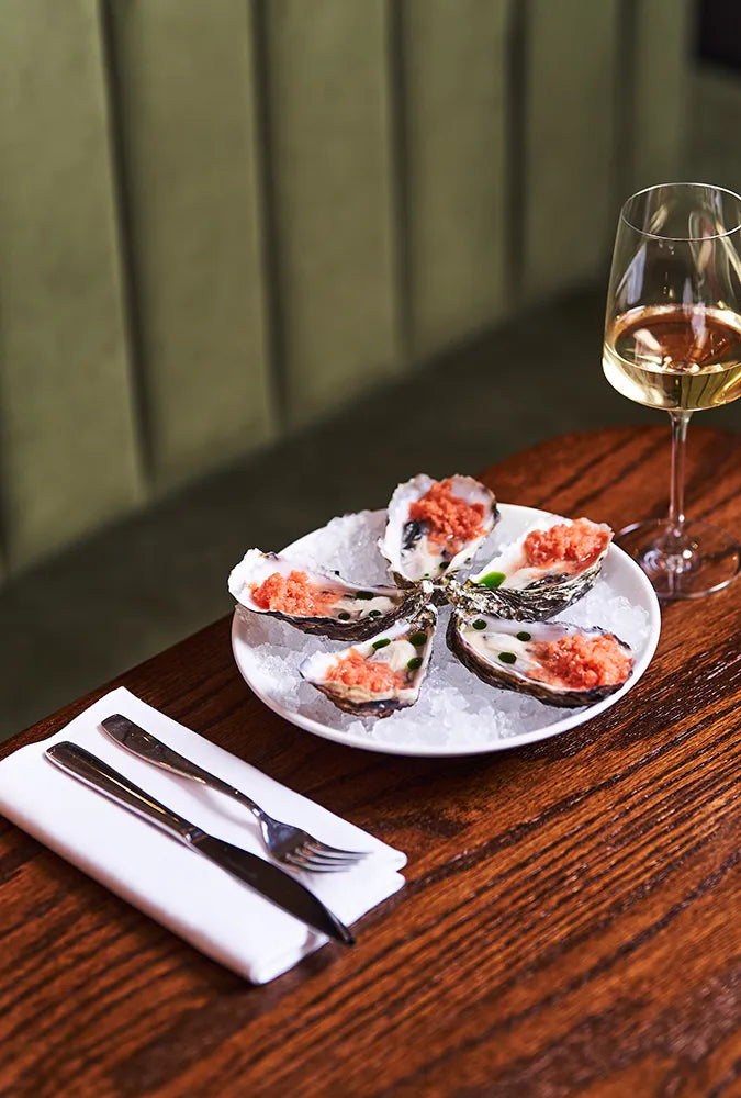 Plate of oysters with glass of white wine