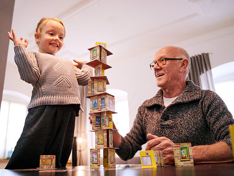 Girl Playing Rhino Hero with Grandpa