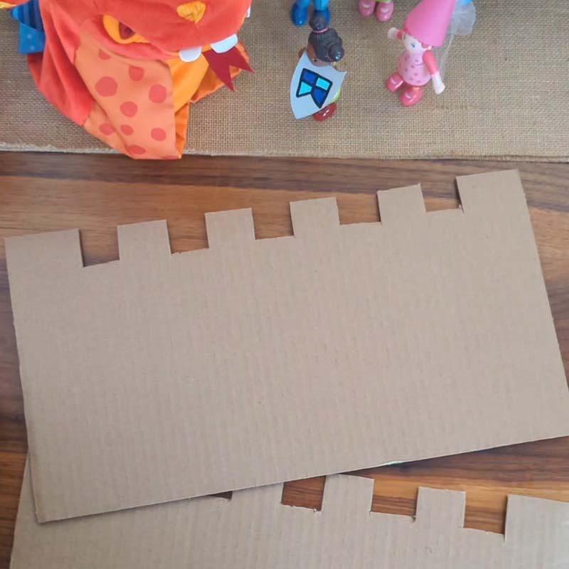 Cut out cardboard shapes in the form of a castle.