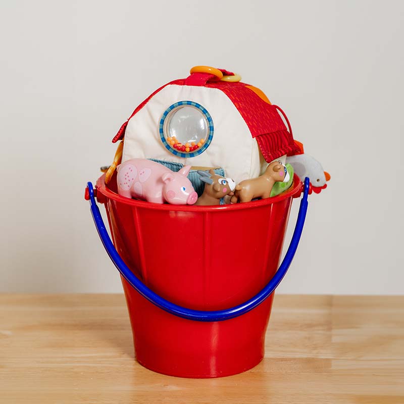 A basket filled with animal toys.