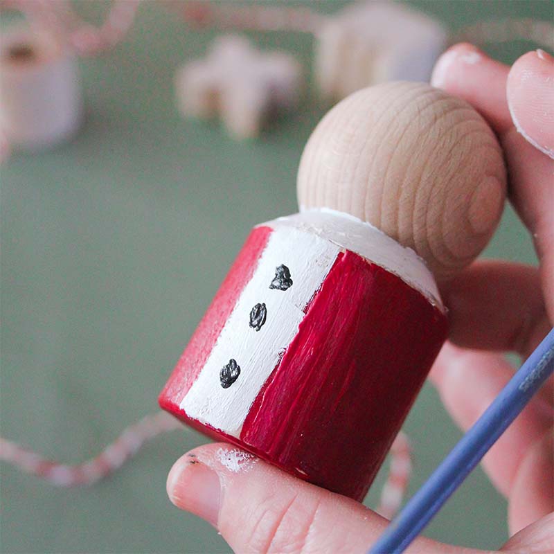 A HABA Block has been painted to look like Santa's coat.