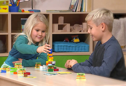 Two kids at a table playing Flotsam Float