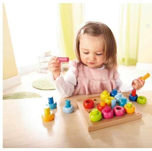 Child playing with a Rainbow Whirls Pegging Game