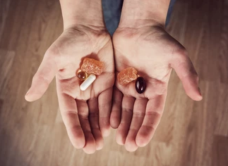 Person holding a variety of herbal supplements