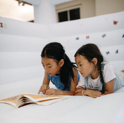 kids reading in bounce house