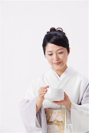 Japanese woman holding a Yunomi tea cup