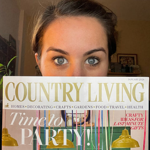 Me holding the cover of the January Country Living Magazine