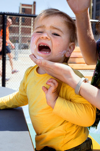 Child crying suncream application