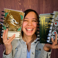 Kylie DeWitt smiling and holding too many notebooks