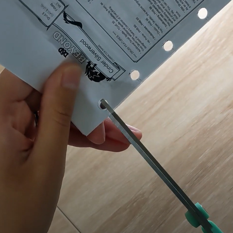 Cutting a piece of paper with a pair of scissors