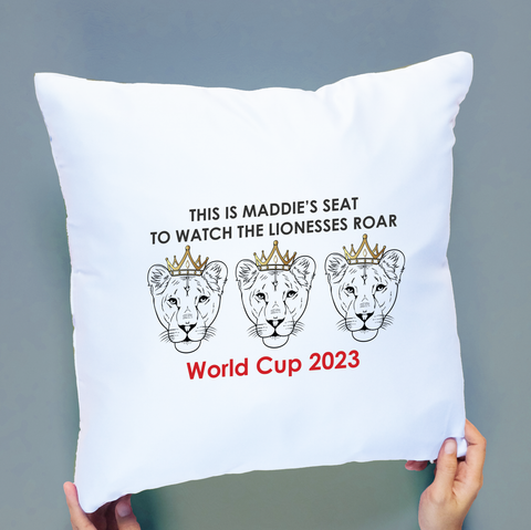 White cushion cover printed with three lionesses with gold crowns to represent the Women's World Cup team and printed with the words this is [insert name] for watching the World Cup 2023