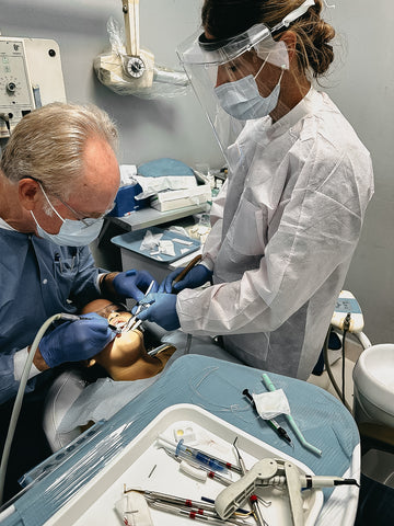 Dentists working on a tooth procedure