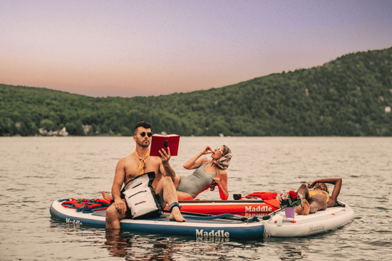 Three people relaxing on paddle boards