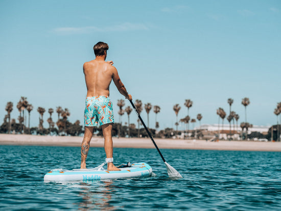 Man standing on a stand-up paddle board