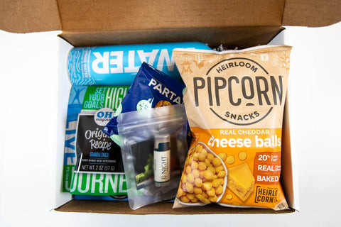 image of conference welcome with water, snacks, and lip balm