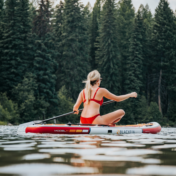 Woman riding BLACKFIN standup paddle board