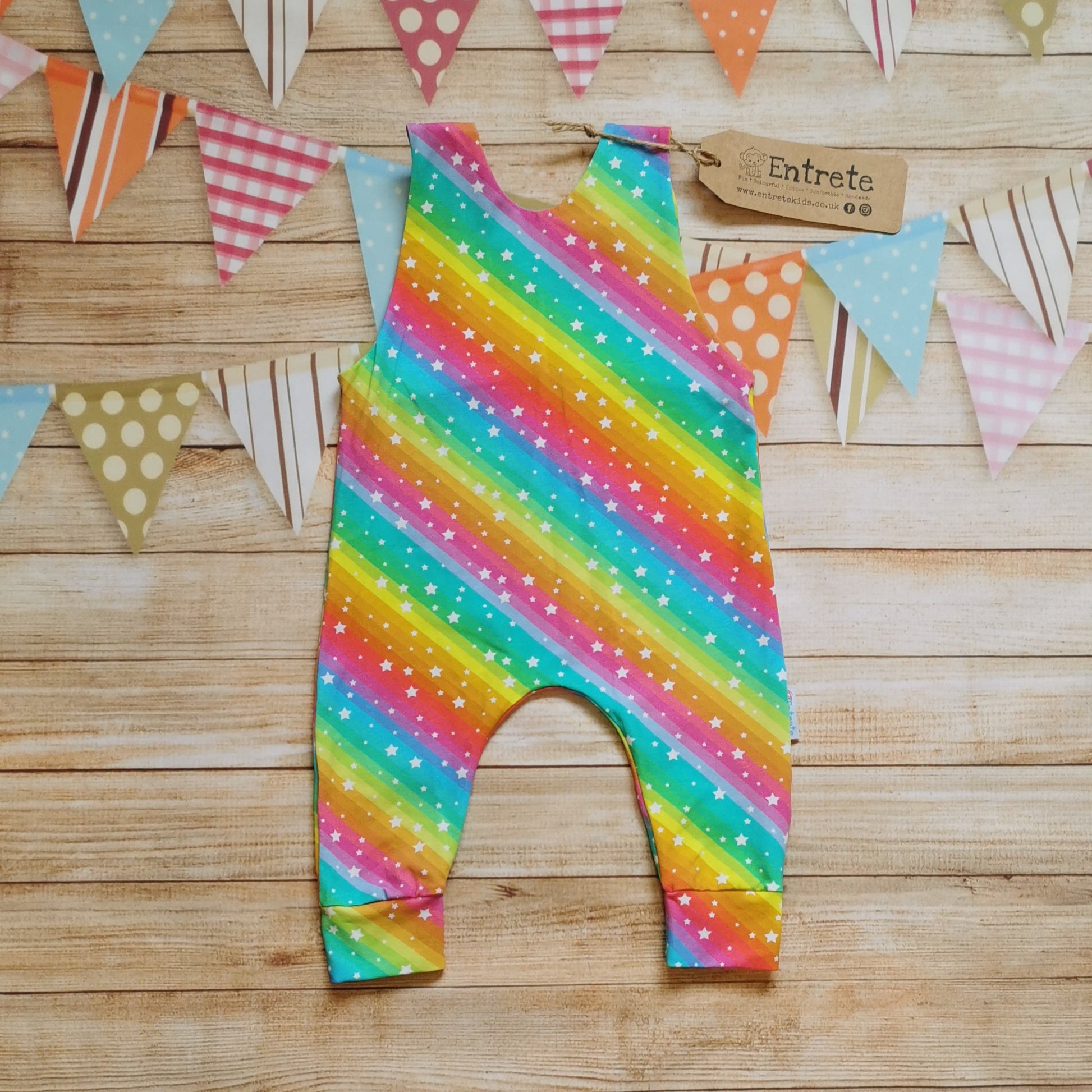 Rear of Girls & babies sleeveless romper, handmade using the vivid bright rainbow stars cotton jersey. With shoulder popper entry.
