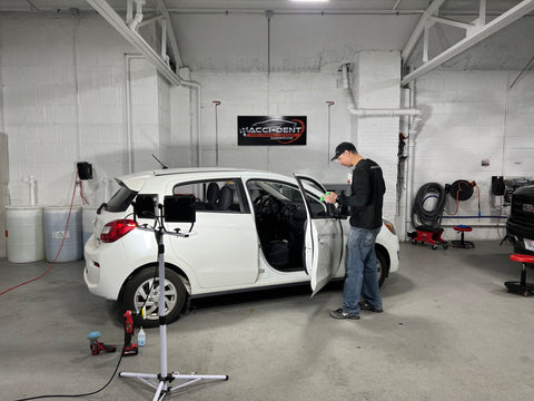 Nick Sanfilippo working on a paintless dent removal in Milwaukee, Wisconsin