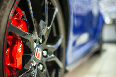 Close up tire photo of a blue, red and black honda 