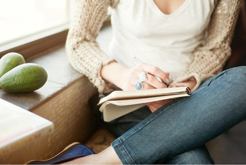 Woman writing in journal