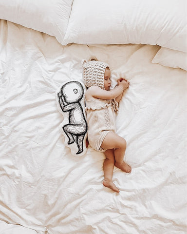 A newborn baby with a birthpillow. Ideal for new moms