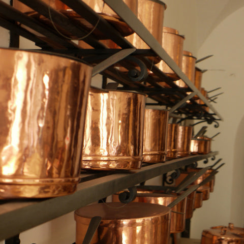 Copper pans on a shelf