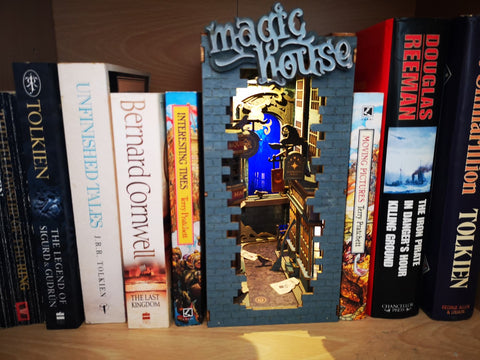Robotime Rolife Book Nook Magic House on a book shelf