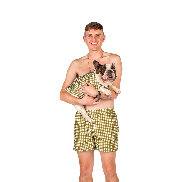 Matching human and French bulldog swimwear. They are green gingham.