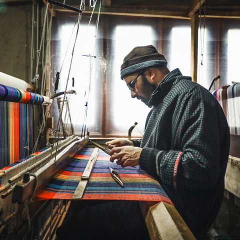 Man weaving cashmere on loom