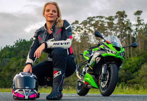 Female motorcyclist modeling a sports style motorcycle jacket