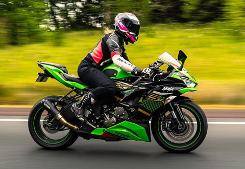 Female motorcyclist riding her sportsbike wearing a REV'IT! race style motorcycle jacket