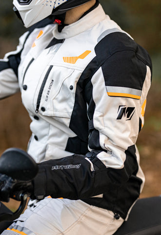 Close up photo of motorcyclist wearing full motorcycle apparel, with focus on jacket fit