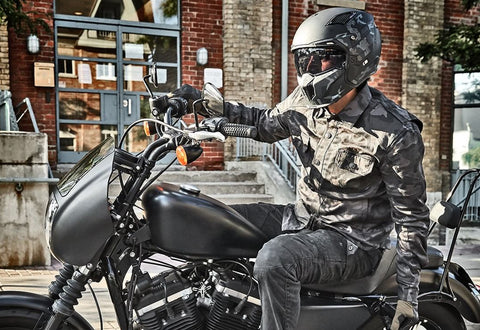 Motorcyclist riding while wearing a protective motorcycle shirt