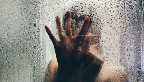 woman in shower with false lashes on