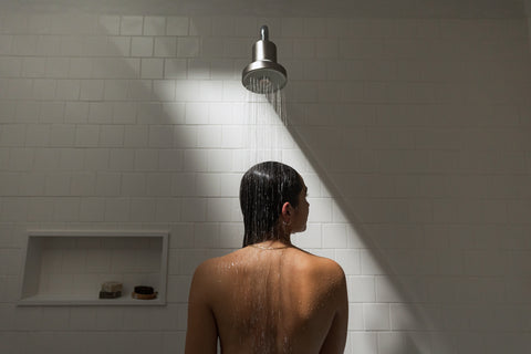 girl using a shower filter for chlorine