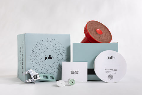 unboxed contents of a Jolie showerhead for male hair loss prevention