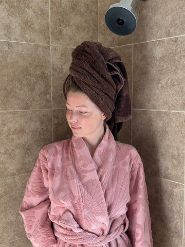 woman with wet hair in a towel and a robe on