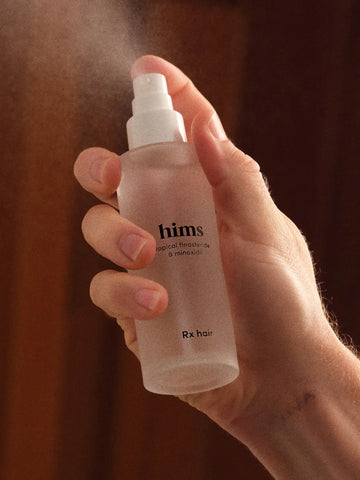 spray bottle of hims for hair loss