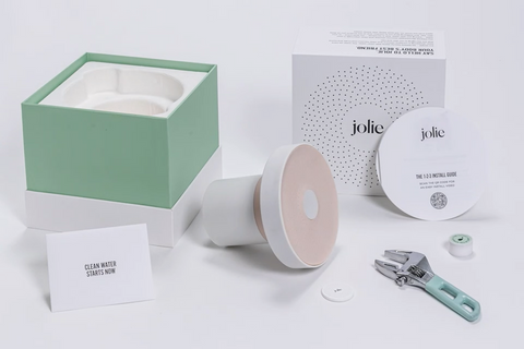 unboxed contents of a Jolie Filtered Showerhead meant for holistic hair care