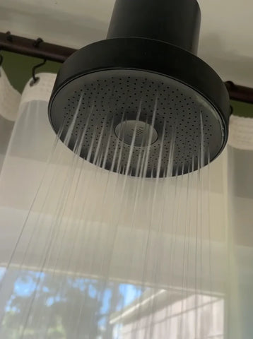 running filtered showerhead used for curly hair loss in shower