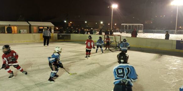 Children playing hockey at the Avalanche Xpress Mite Outdoor Classic.