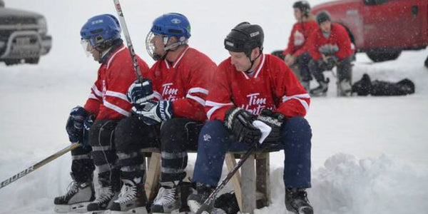 Players on a bench at the Lake Scugog Hockey Charity Tournament.