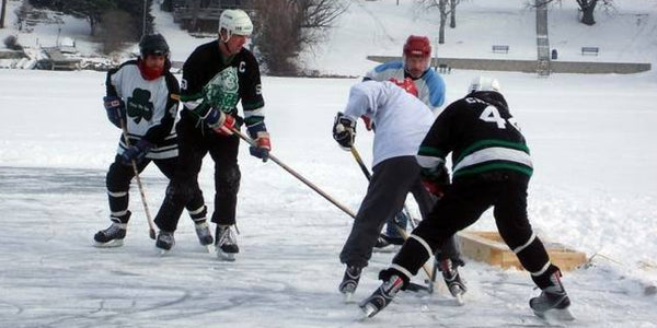 Image of players on the ice at the Lake in the Hills Pond Hockey Tournament.