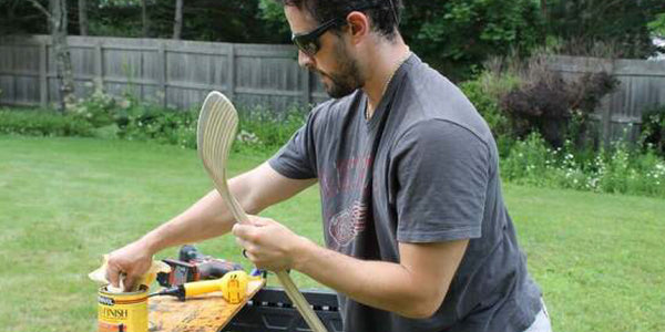 Third Assist Founder, Christopher DeVore, apply finish to his DIY hockey stick.