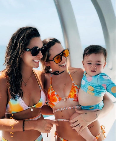 Two women and a baby supporting Wild & Pacific at Miami Swim Week