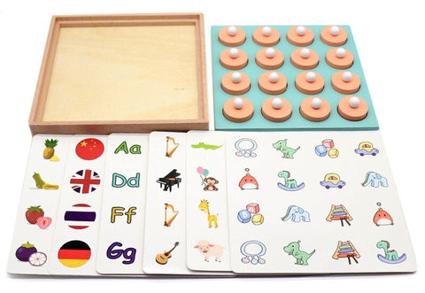 Educational materials including InvenToy's Montessori Memory Game with circular sandpaper discs, flashcards featuring brightly colored images and letters, and an empty wooden tray on a white background.